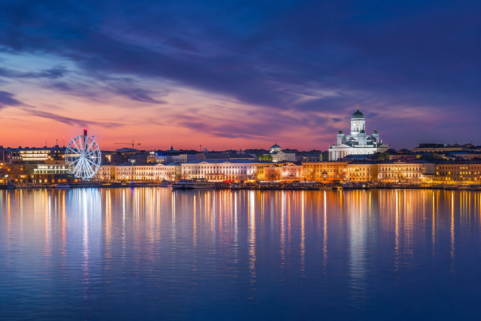 Helsinki skyline panoramic view at twilight with city lights reflected in bay